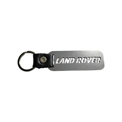 Брелок з металу та назвою марки Land Rover